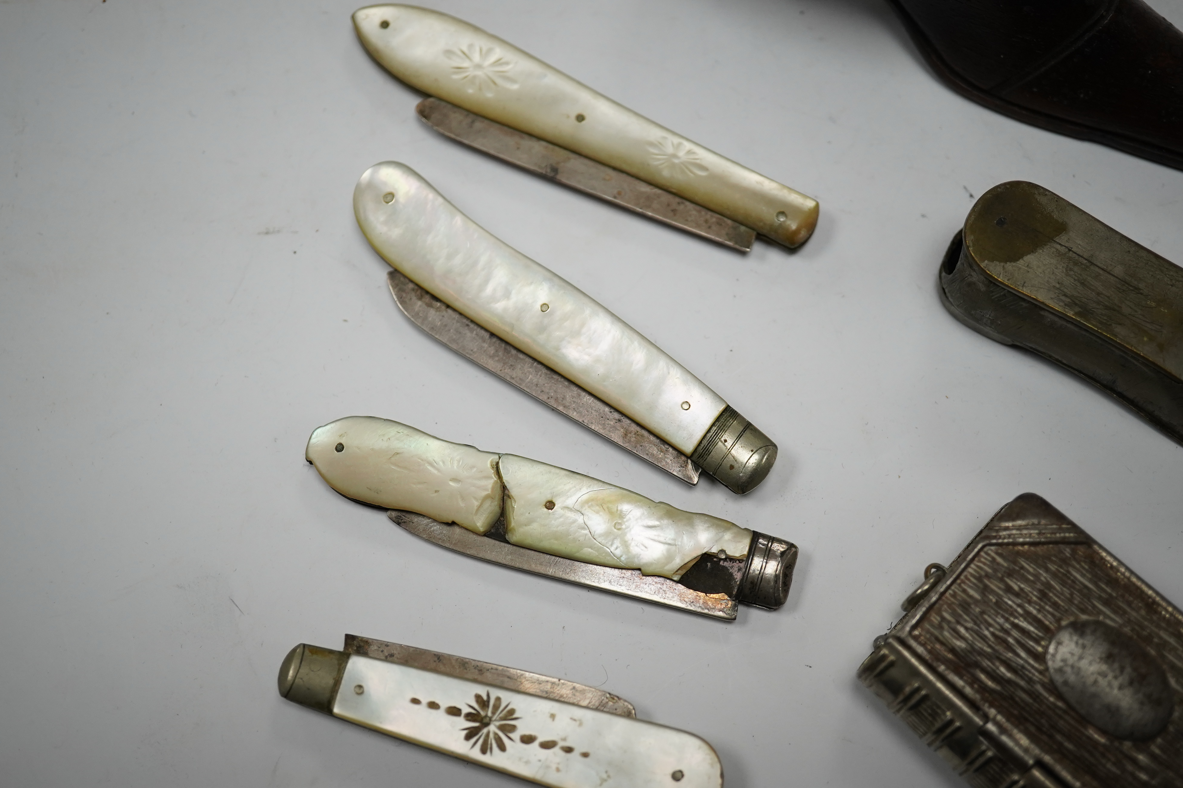 Four mother-of-pearl penknives, two vesta cases and a treen shoe, treen shoe 10cm long. Condition - fair